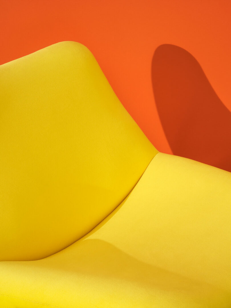 closeup partial view of bright yellow upholstered chair