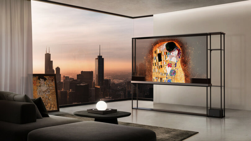 LG OLED Signature T in the middle of a large contemporary living room with large cityscape views and a Klimt painting displayed across the television.