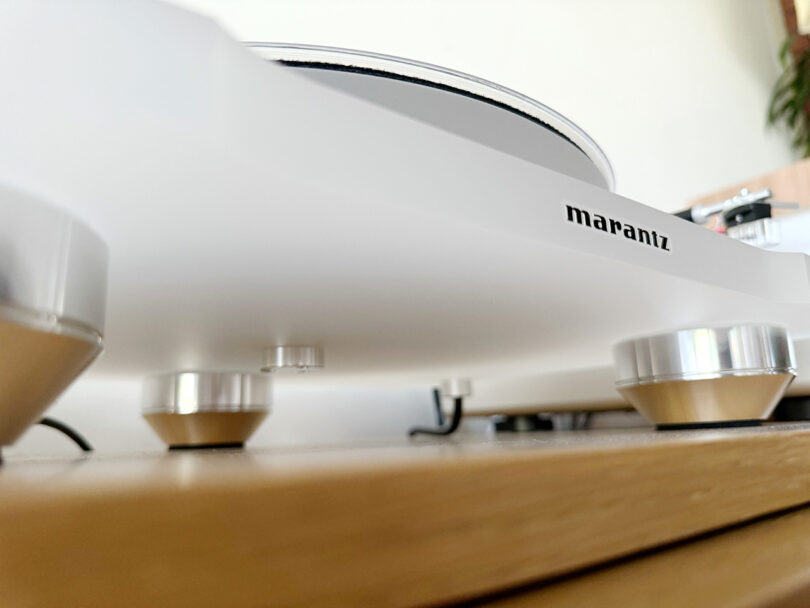 Underside shot of the Marantz TT-15S Reference Series turntable revealing a trio of vibration isolating metal feet.