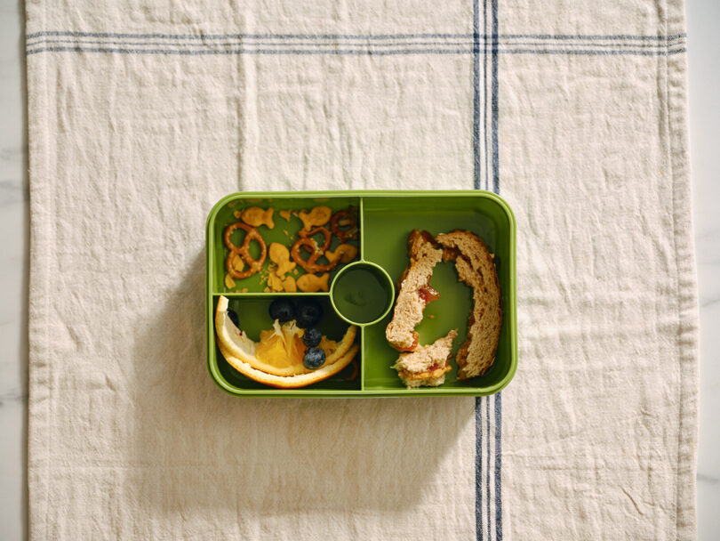 overhead image of green dish with food scraps
