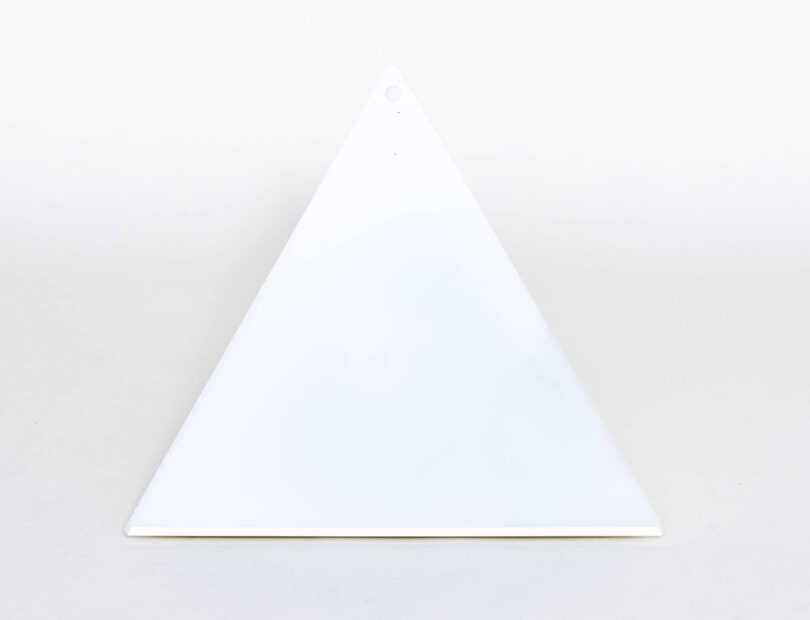 Pyramid shaped LUXOR Desk Lamp, front view turned off, against white background.
