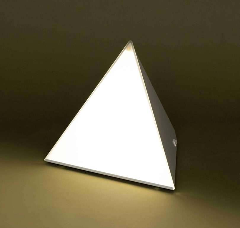 Northern Lights LUXOR seasonal affective disorder pyramid shaped lamp angled and illuminated.