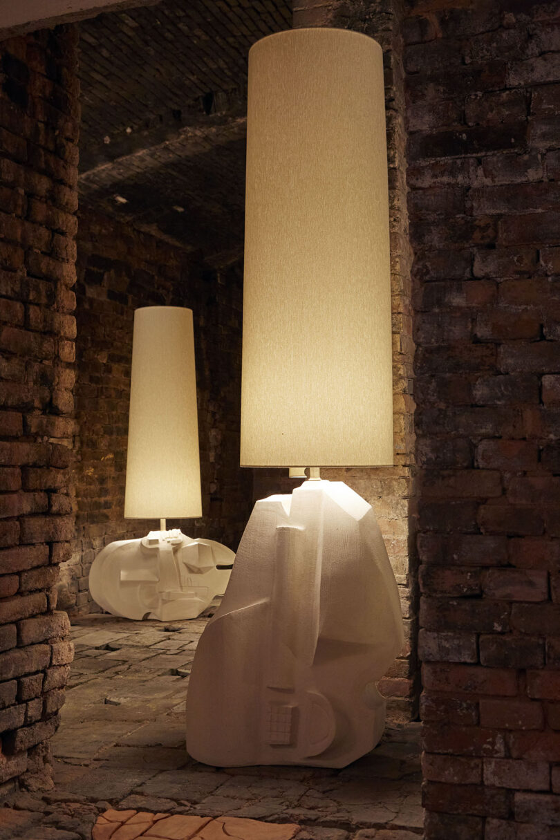 two ceramic lamps with organic stone-shaped bases and oversized shades