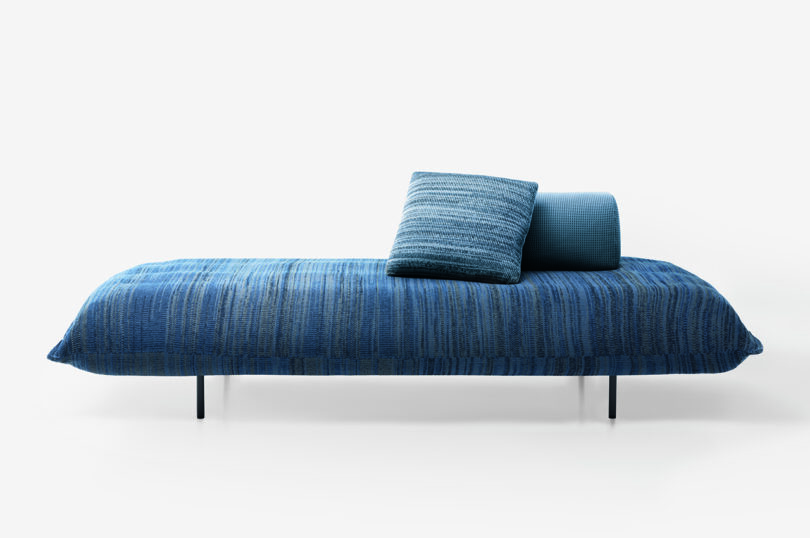 blue cushioned platform seating with pillows