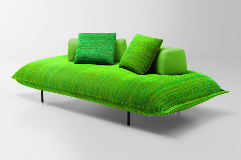 green cushioned platform seating with pillows