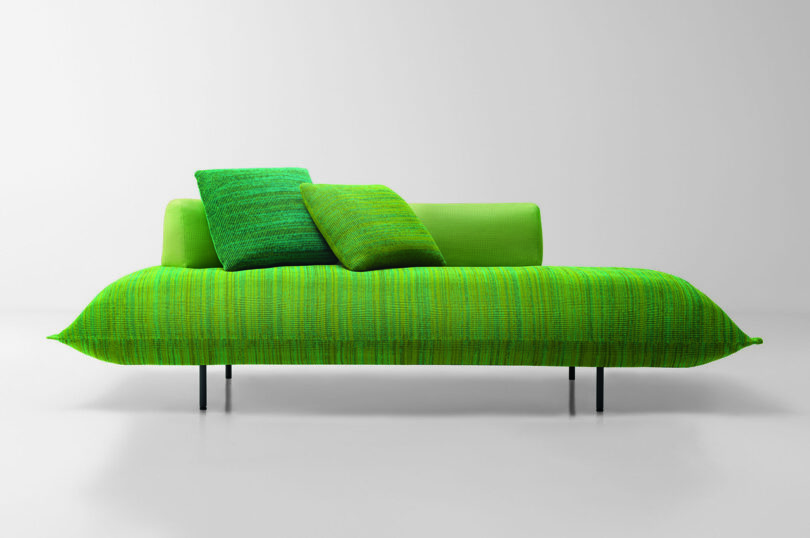 green cushioned platform seating with pillows
