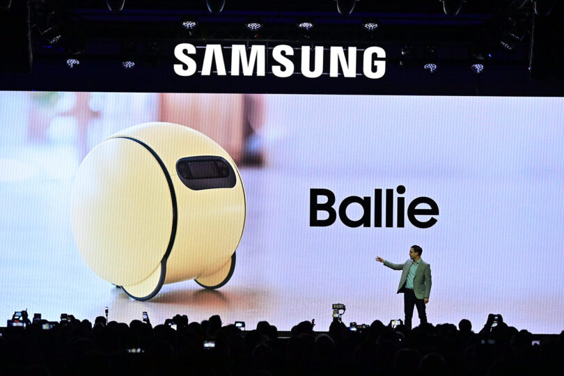 Samsung executive presenting Ballie AI robot on stage at CES 2024