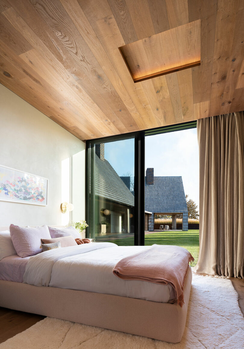 angled view of modern bedroom with sliding glass doors looking out to rest of the house