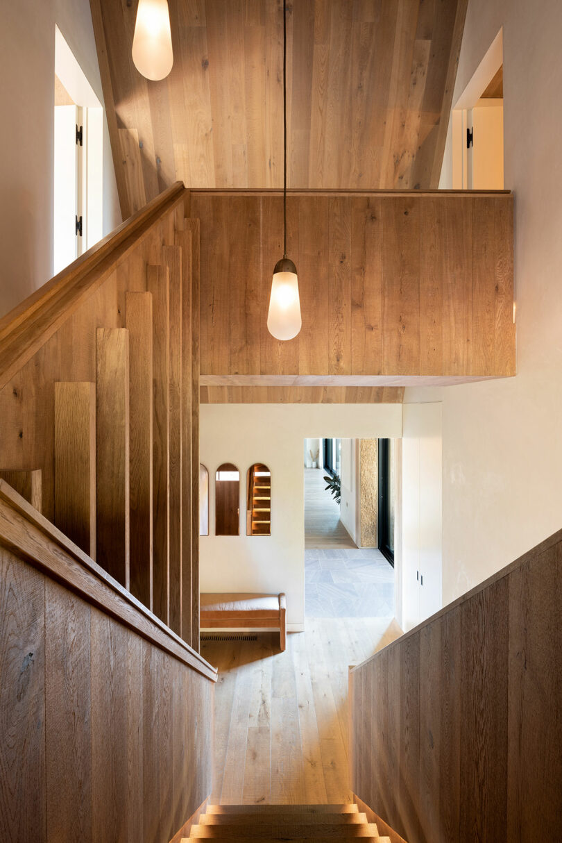 modern interior shot looking down wood staircase
