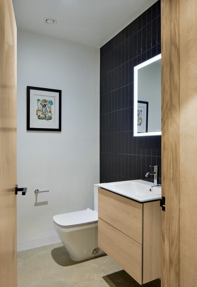 Bathroom with black accent wall.