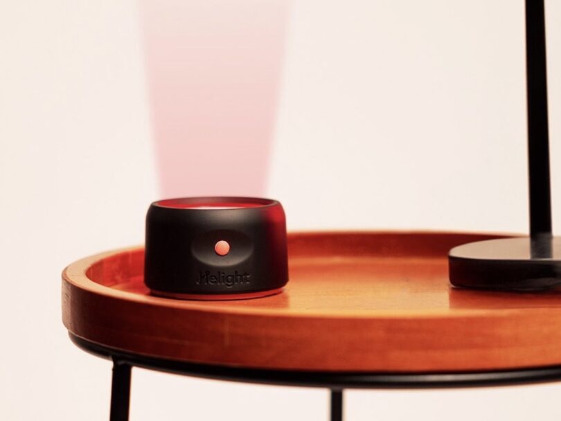 Helight Sleep red light therapy device on a wood side table