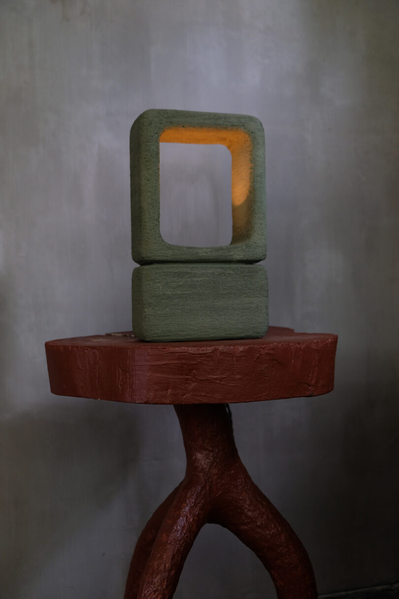 dark green handmade lighting object on a side table