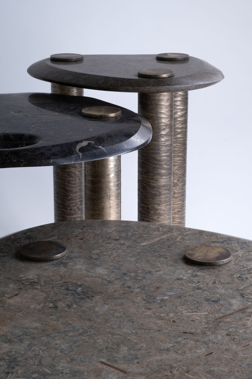 detail of three metal and marble tables