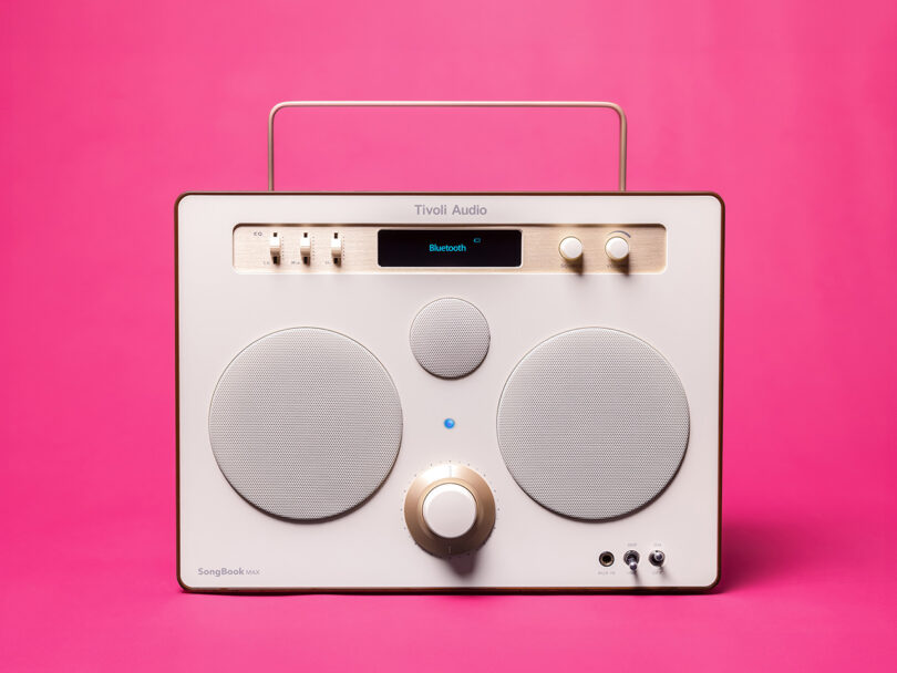 white modern boombox wireless speaker connected pinkish background