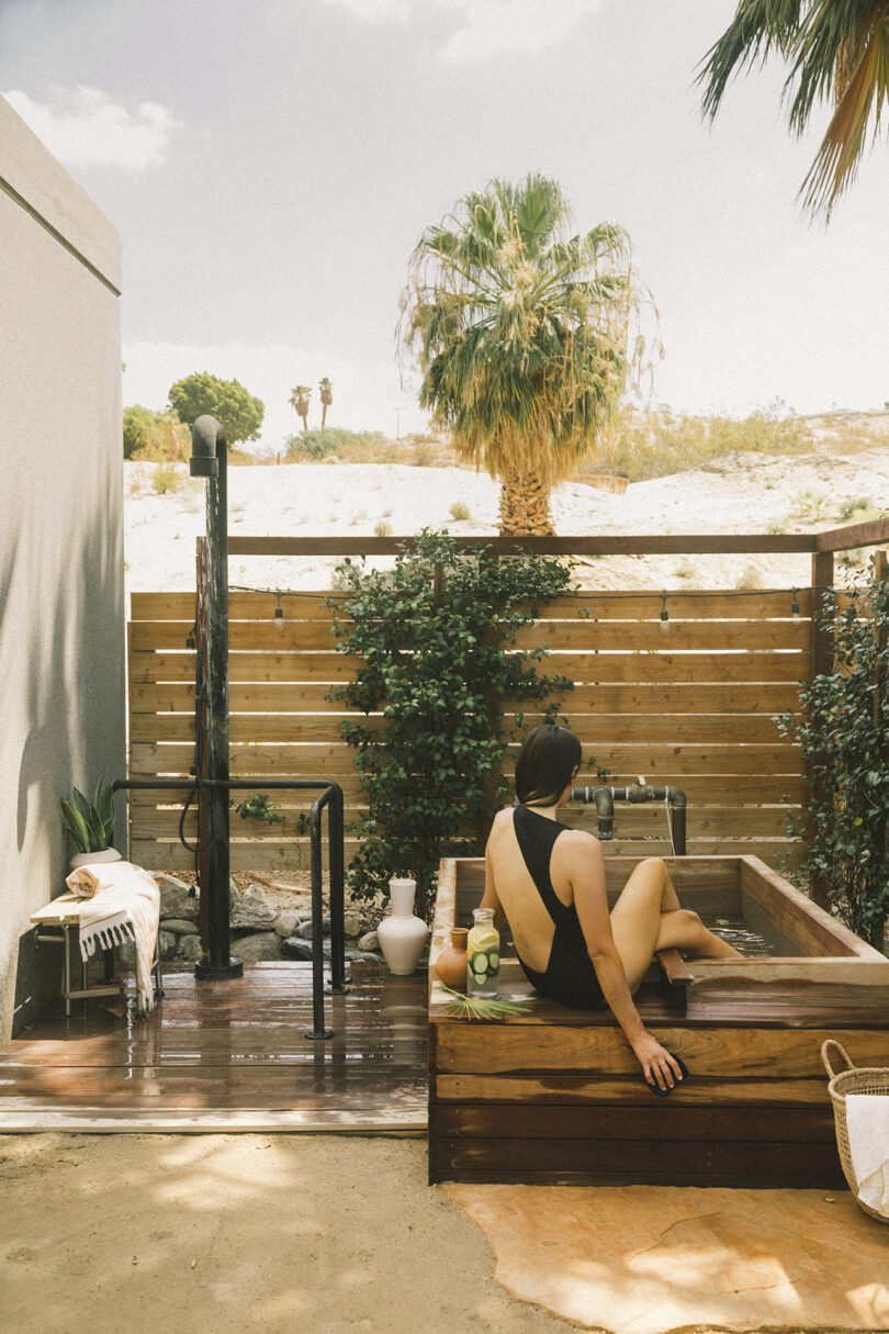 Woman soaking in private outdoor soaking tub at Two Bunch Palms
