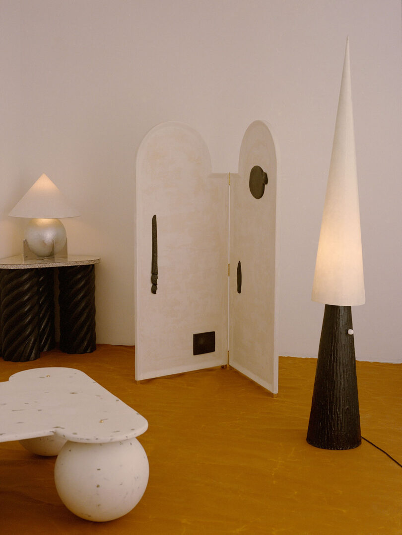 styled interior abstraction pinch array lamp, area table, level lamp, java table, and bifold screen