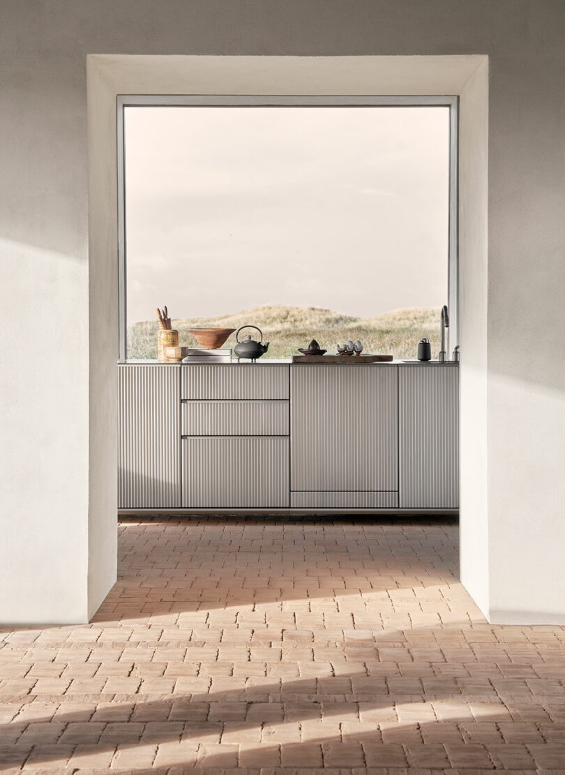 looking through door into modern kitchen with aluminum island