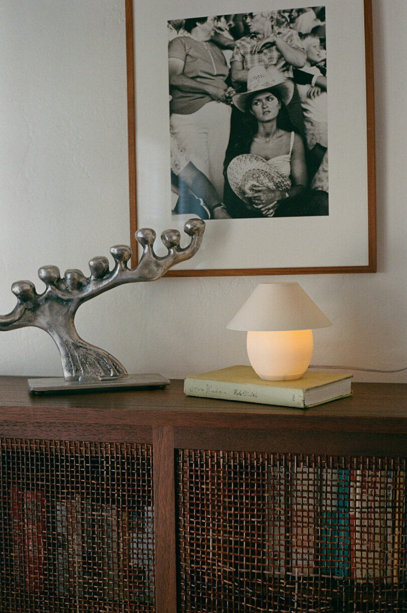 A mini orb-shaped lamp pinch accepted shadiness sitting connected a broadside table.