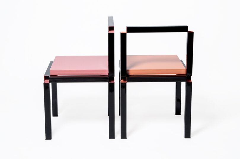 zero-thickness black framed chairs with pink and peach seats on white background
