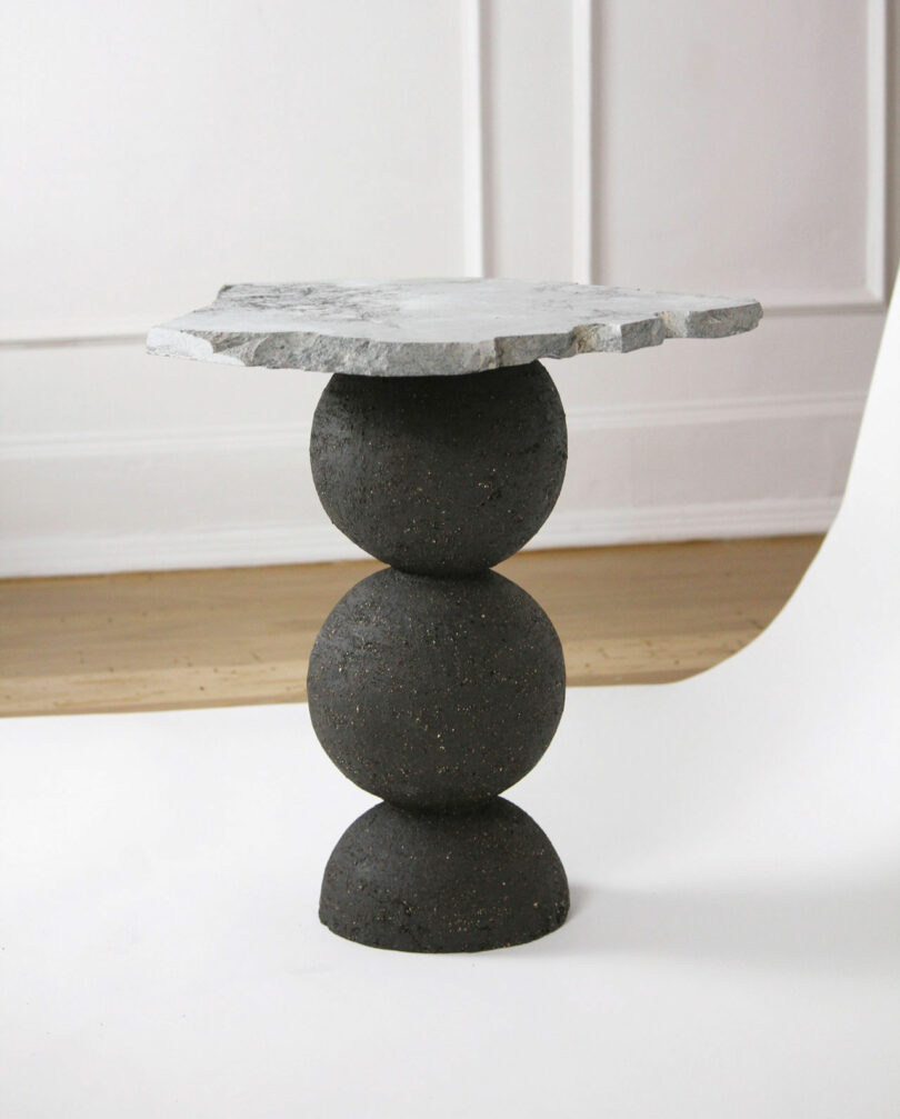 black table with stacked balls and stone tabletop