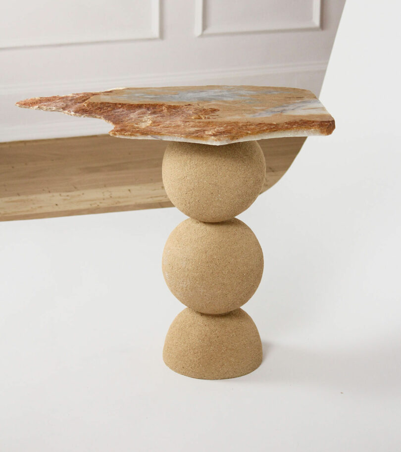 brown table with stacked balls and stone tabletop