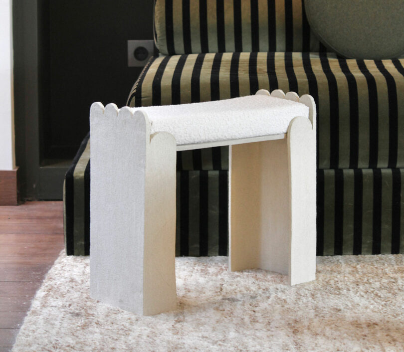scalloped beige ceramic bench with boucle upholstery