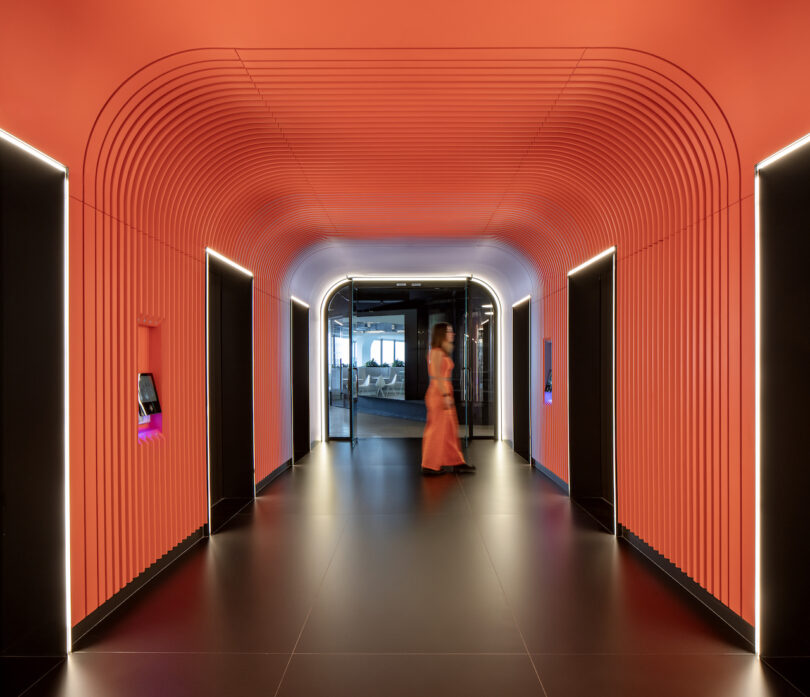 person walking in orange hallway