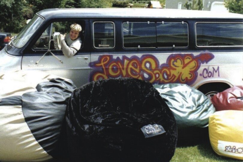 man in van with lovesac seats in front of it