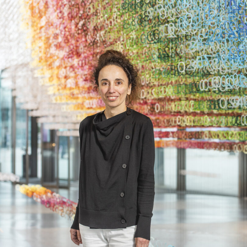 woman adjacent a colorful installation