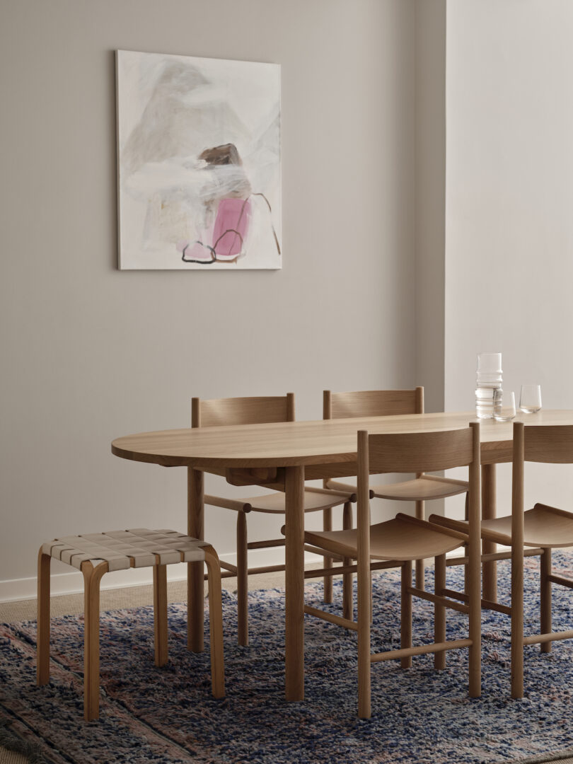 wood table with wood chairs and white stool