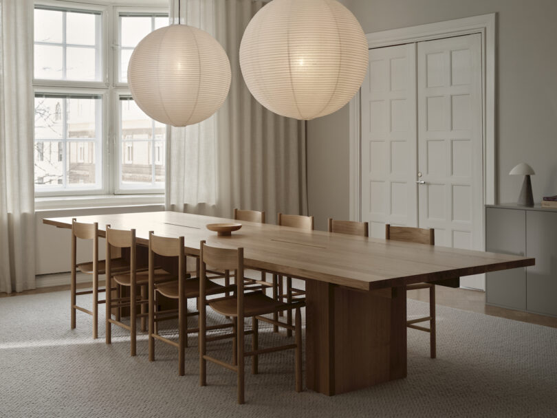 long conference table under two paper pendant lights