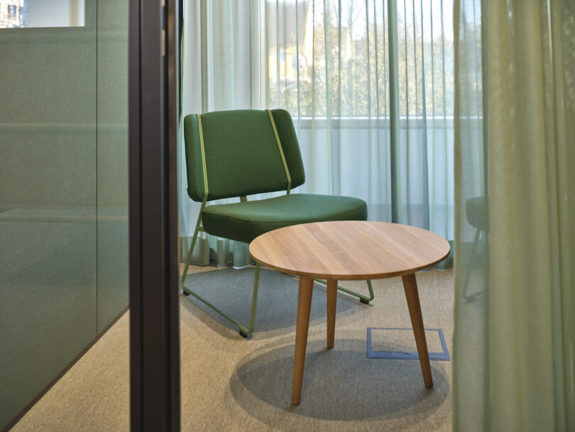 green chair and wooden side table in conference room