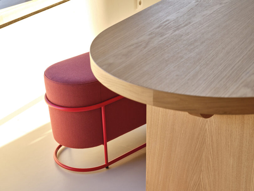 red bench next to wooden rounded table