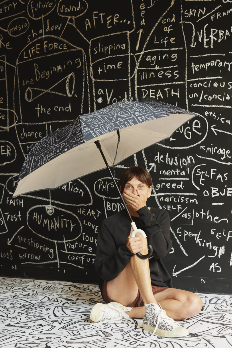 woman holding schematic umbrella successful beforehand of schematic wall mural