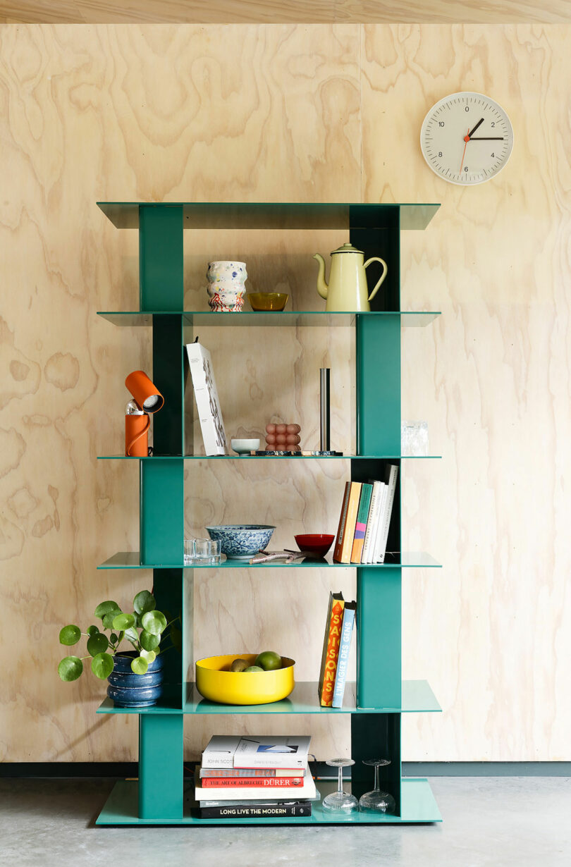 green multi-level metal shelf with objects on it