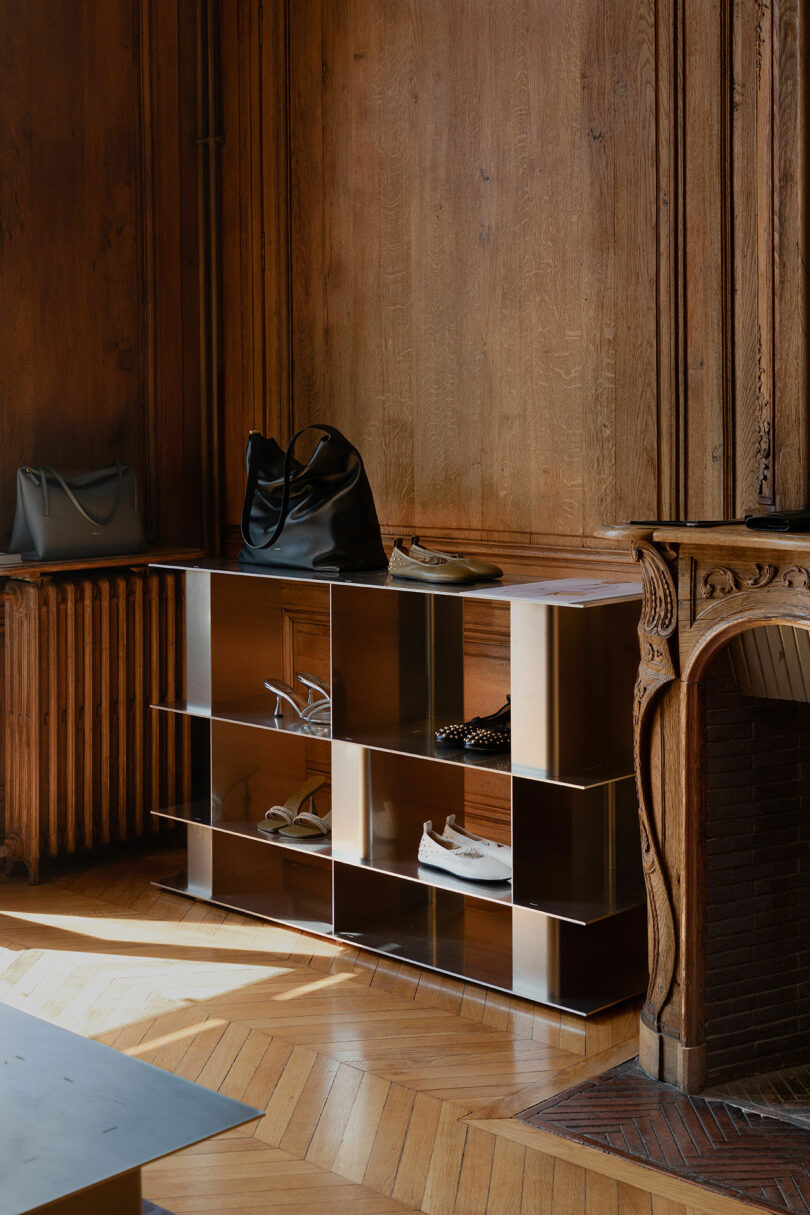 aluminum modular shelving system with shoes on it in wood paneled room