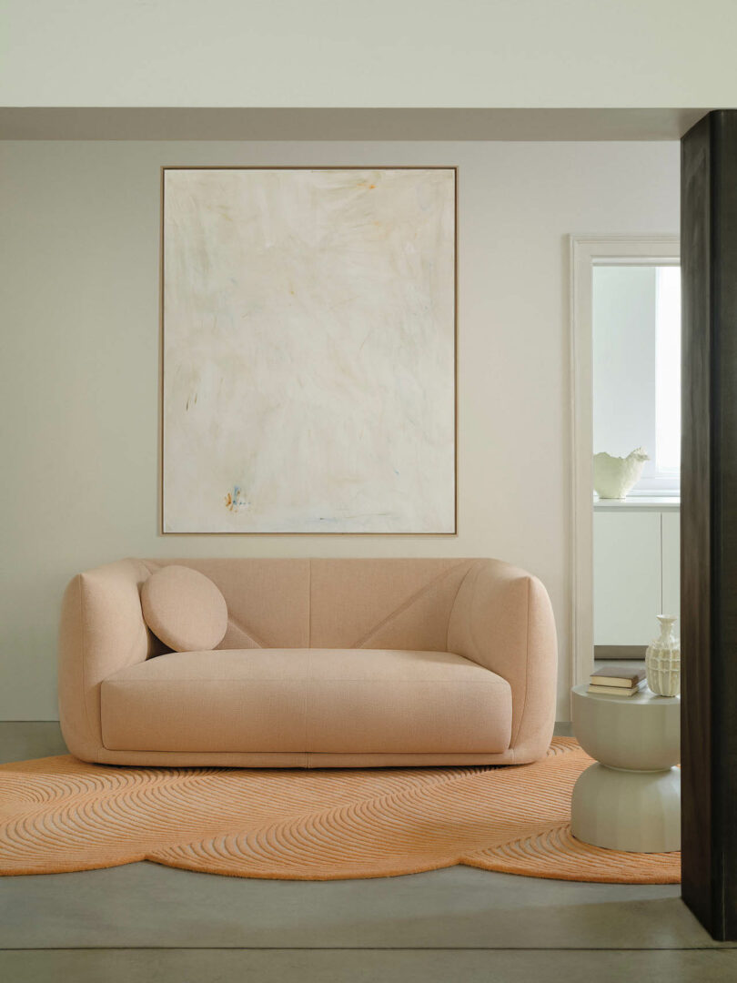 pink sofa under a large painting