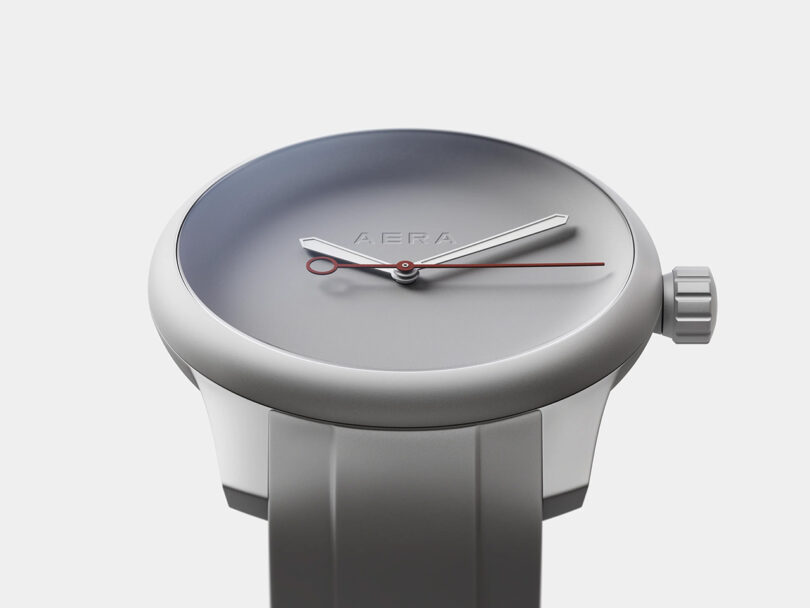 Minimalist Firmship Aera x P–1 Titanium edition with Battleship Grey Rubber strap and three-hand display with prominent crown.