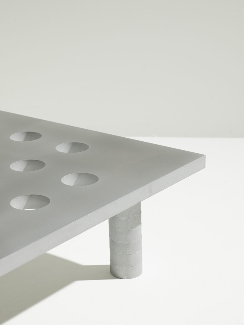detail of square metal coffee table with tabletop perforations