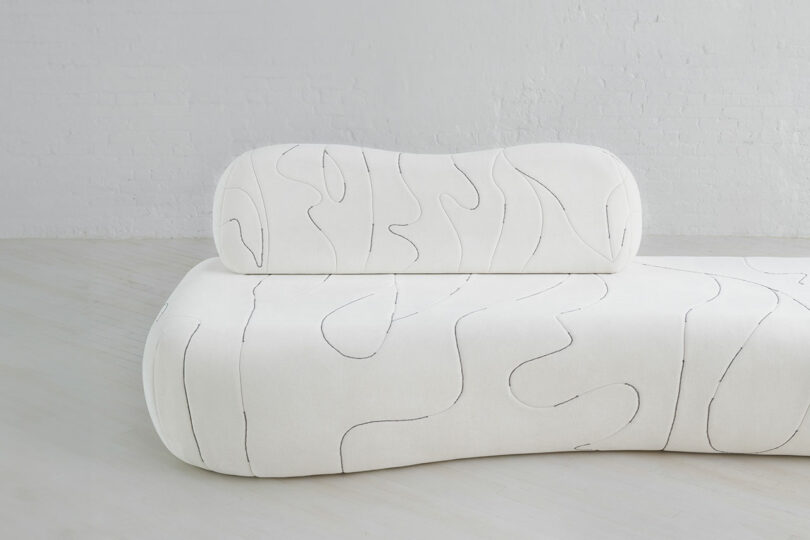 A sofa with line work.