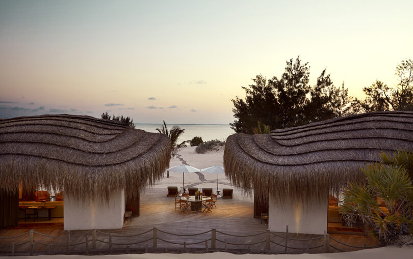 Two thatched Residences overlooking the setting sun of the Indian Ocean.