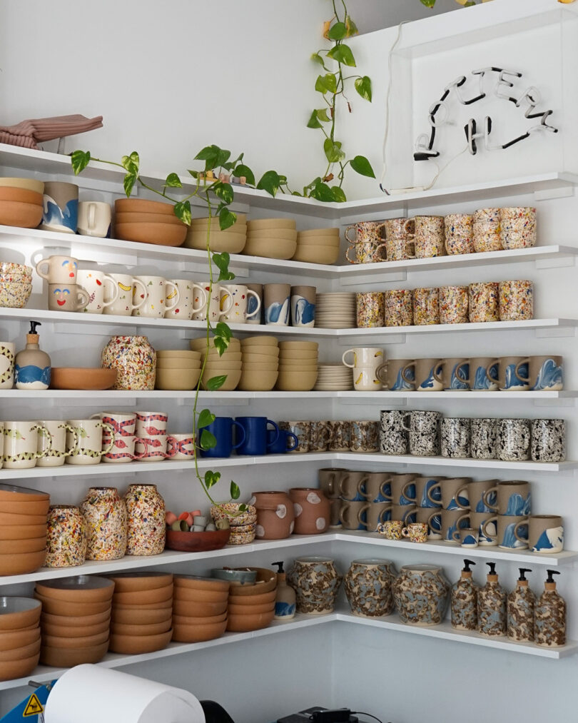 wall shelves stacked with colorful ceramics