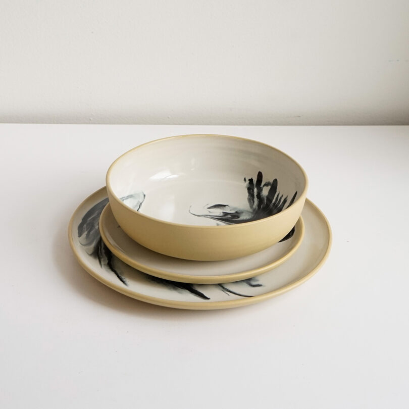stacked handmade dinner plate, salad plate, and bowl