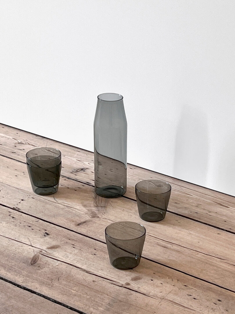 grey glass carafe and three matching glasses