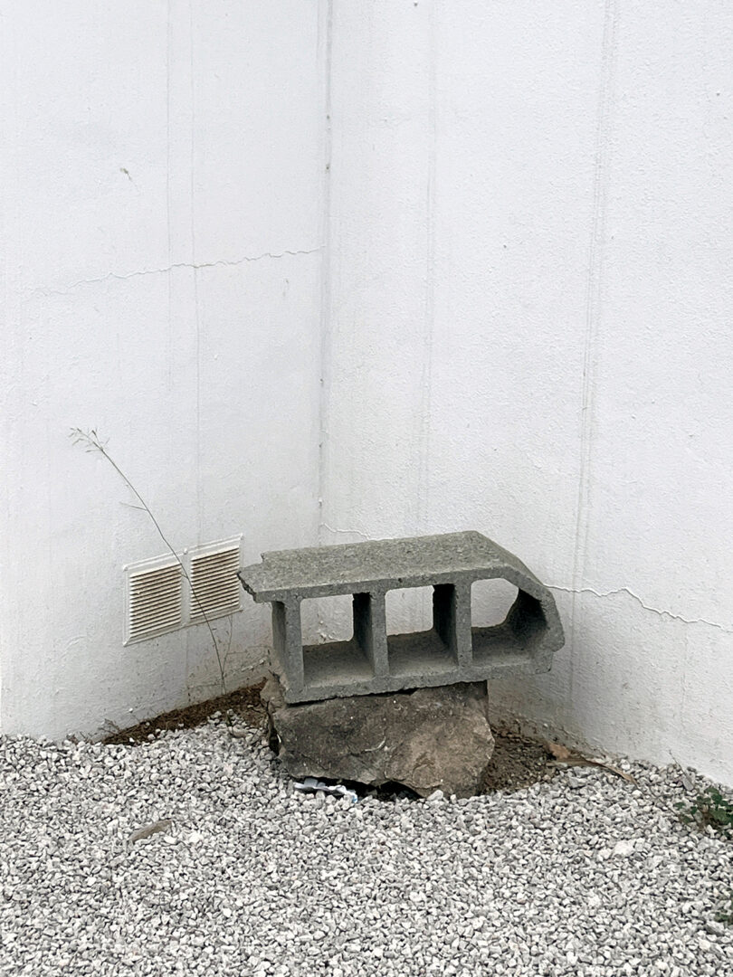cement block and rock stacked in a corner