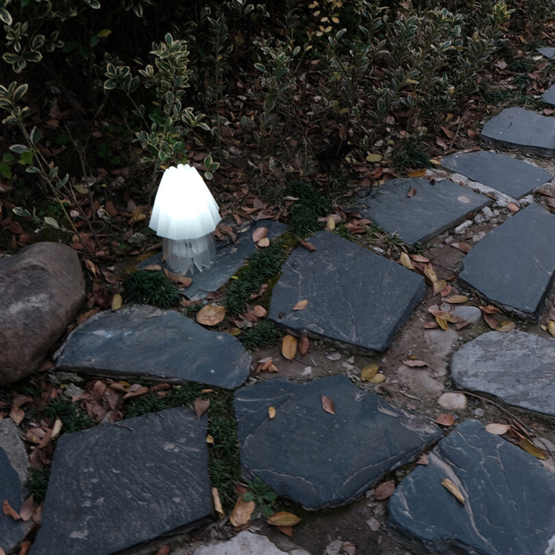white outdoor lamp next to a stone pathway