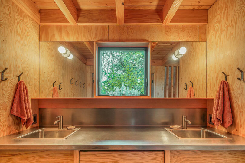 interior view of rustic modern cabin with open bathroom and two sinks