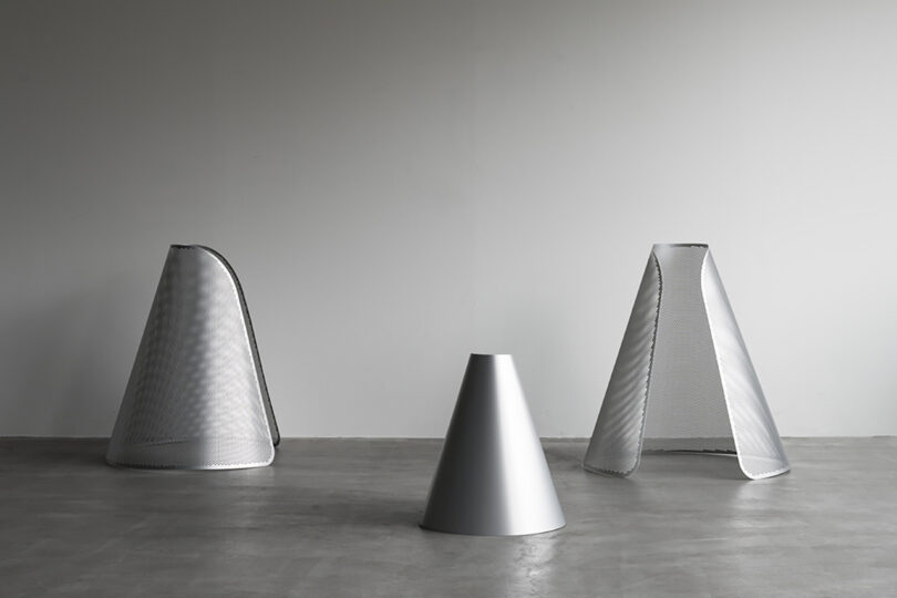 three conical light artworks of different sizes