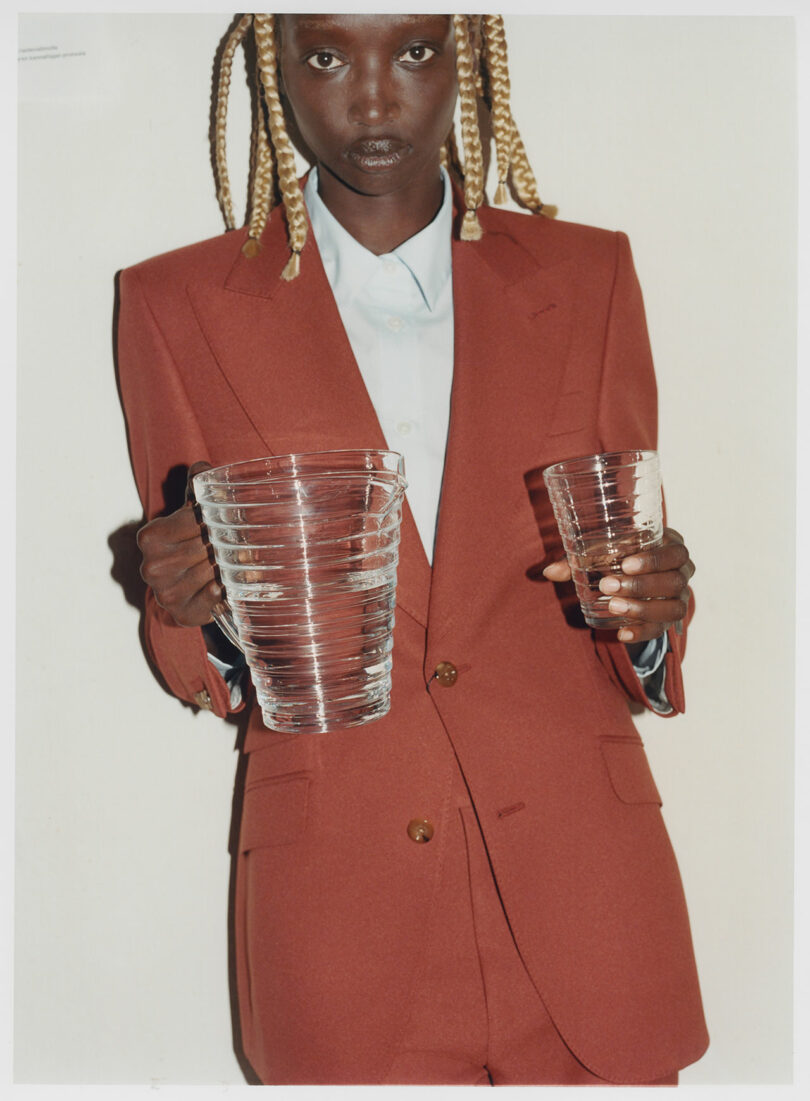 A woman holding glass cups.