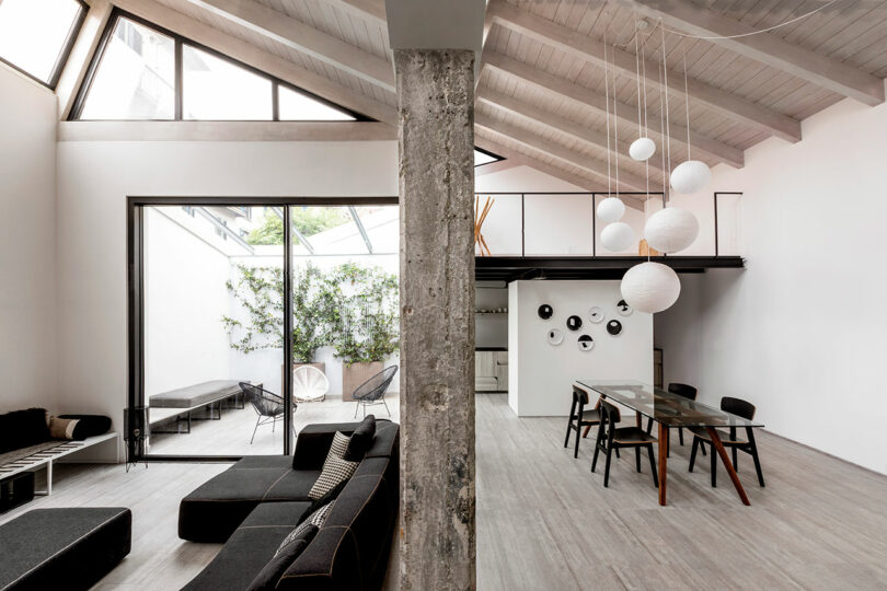 interior shot of large open loft apartment with black and white furnishings